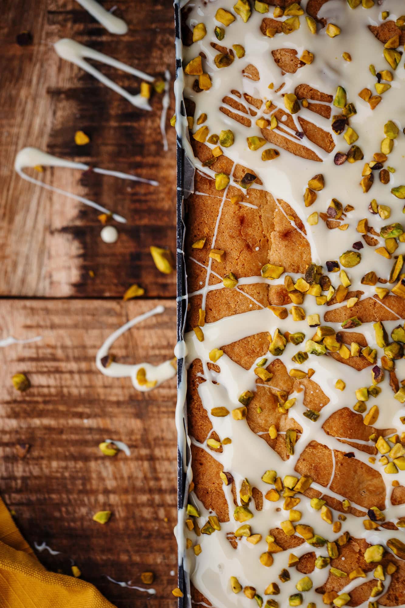 Rutland Food Photographer - pirstachio and icing on a bakewell tart tray bake