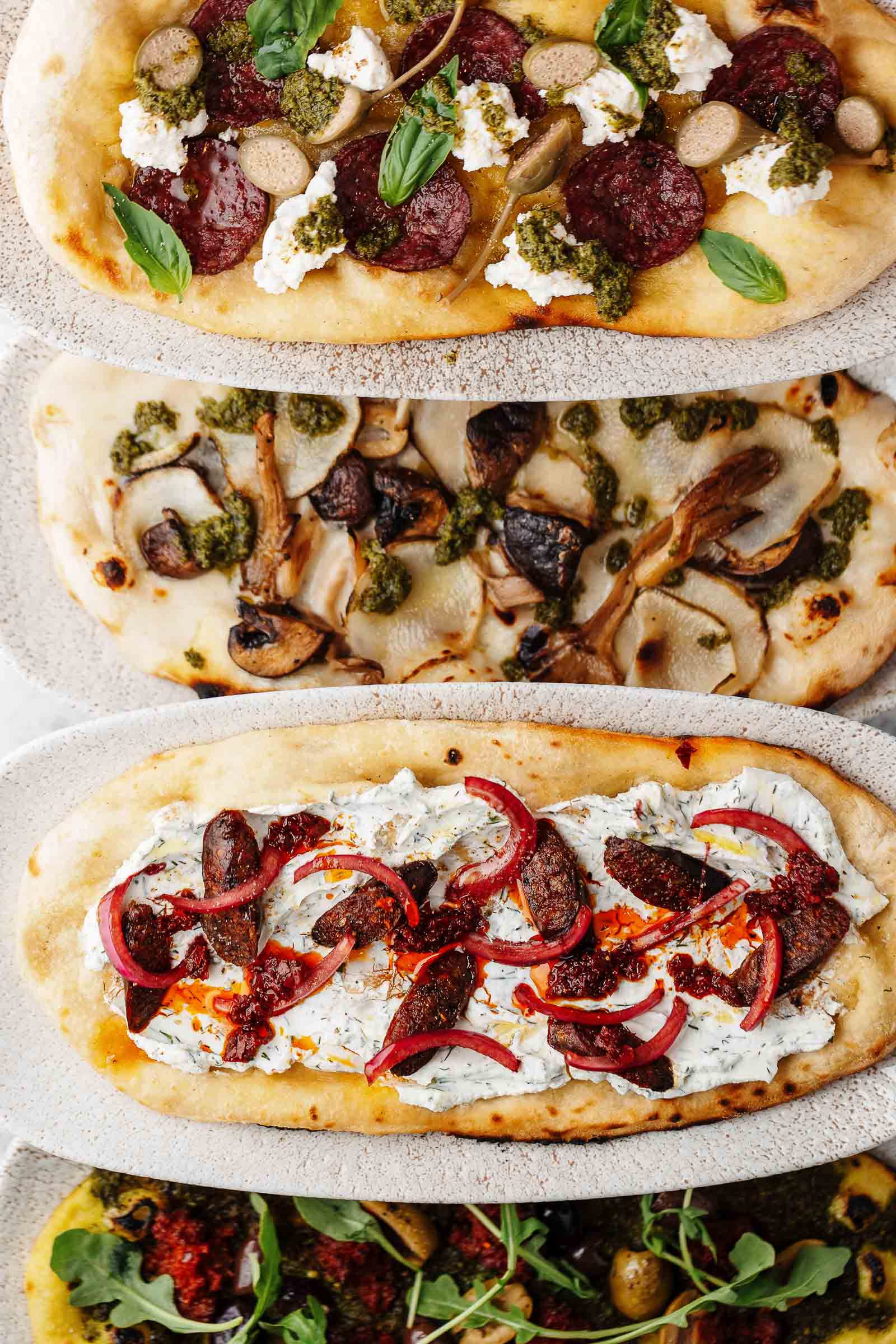 Three different flatbreads in a line
