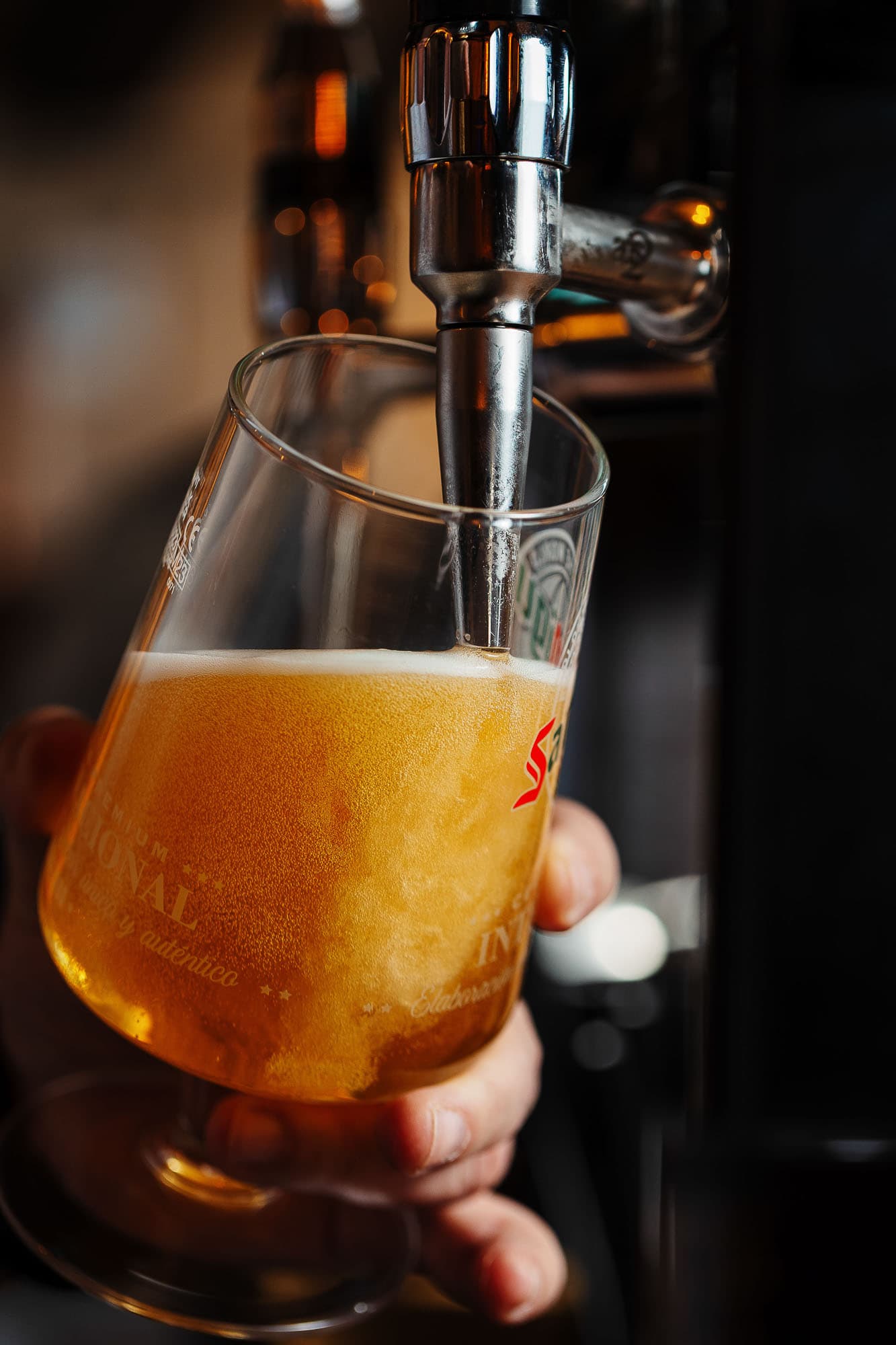 Fresh craft beer being poured from a tap into a branded glass at a Rutland-based food and drink venue, showcasing high-quality food photography expertise.