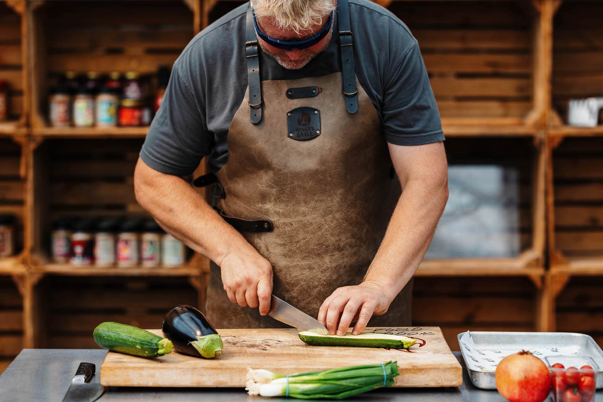 Fresh zucchini and eggplant being sliced by a professional food photographer in a rustic kitchen for vibrant food styling and marketing.