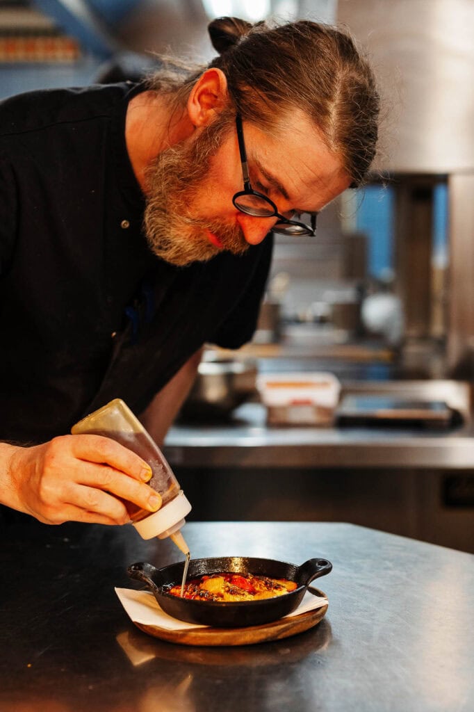 Freshly prepared gourmet dish being garnished by a professional food photographer in Rutland, capturing the essence of high-quality food photography.