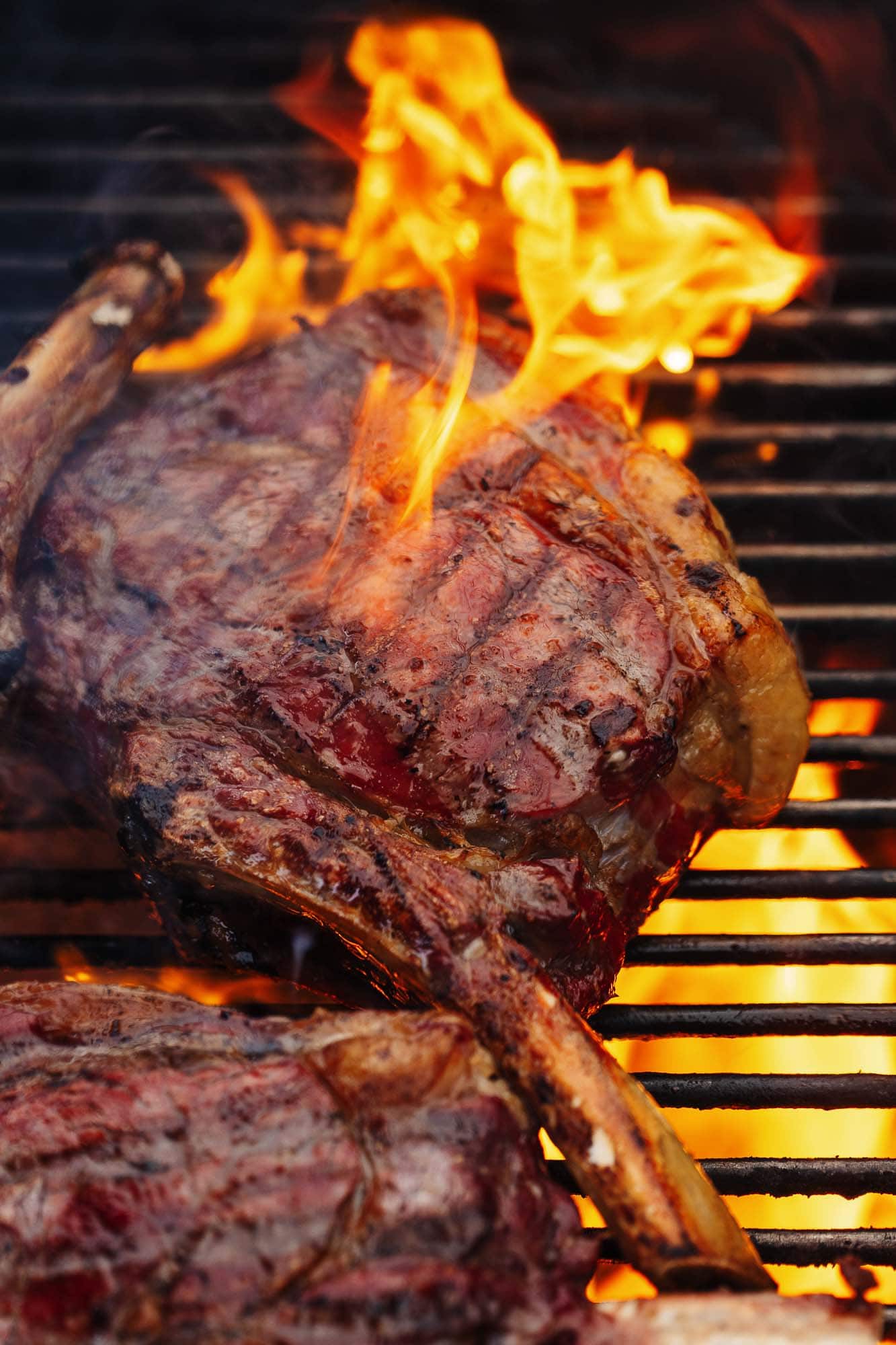 Succulent grilled steak on BBQ grill with flames, perfect for food photography in Rutland. High-quality meat shot, ideal for restaurant, catering, or food blog visuals.
