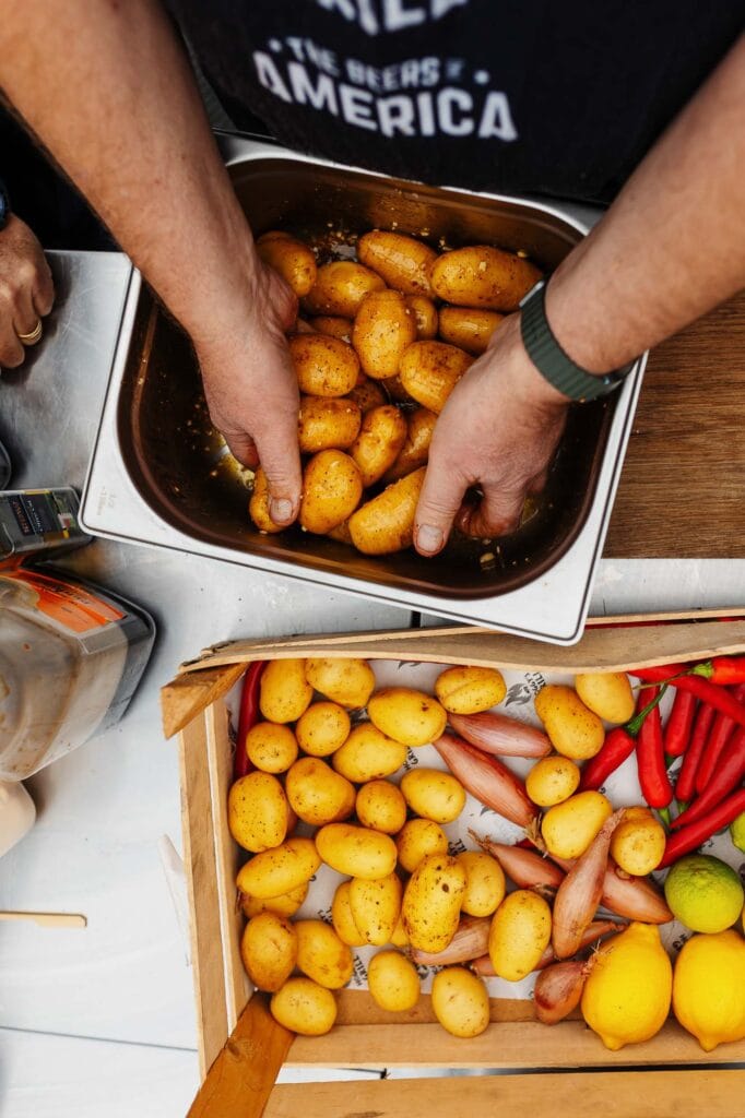 Fresh new potatoes being prepared by a food photographer for a culinary shoot in Rutland, showcasing vibrant seasonal ingredients for appetising food photography.