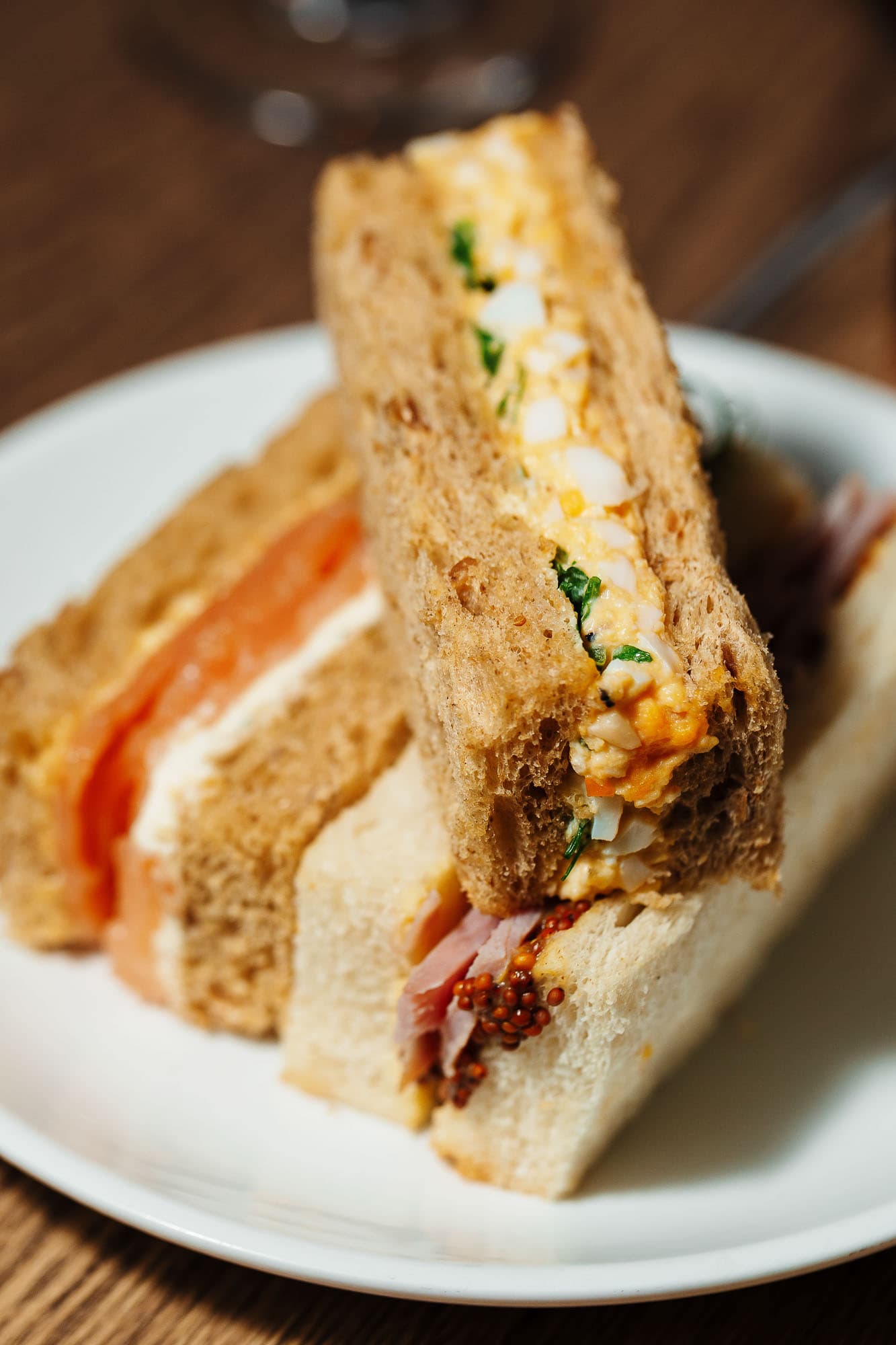 Freshly made gourmet sandwiches on wholegrain bread, featuring eggs, ham, and mustard, perfect for takeaway or catering. High-quality food photography by Rutland Food Photographer.