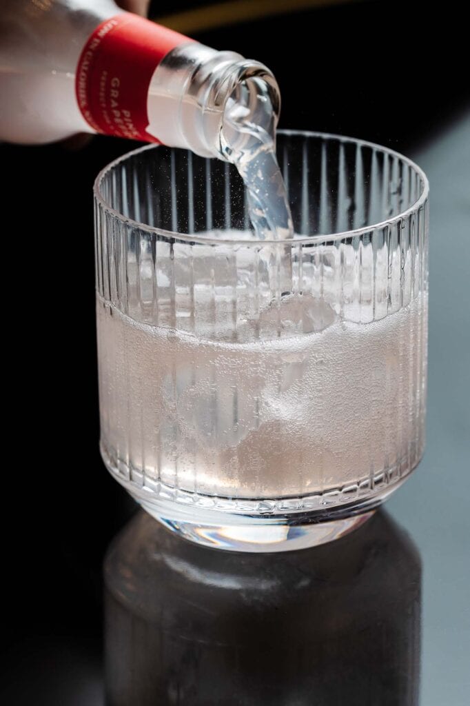 1. Crystal glass being filled with sparkling water, high-quality food photography for Rutland food photographer, showcasing beverage presentation and drink photography.
