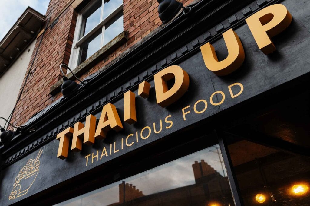 Thai'd Up Thai Delicious Food restaurant sign showcasing authentic Thai cuisine in a vibrant urban setting. Perfect for food photography and restaurant branding.