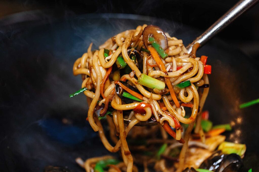 Delicious stir-fried noodles with fresh vegetables, captured by Rutland Food Photographer, showcasing vibrant colours and textures perfect for food blogs and culinary promotions.