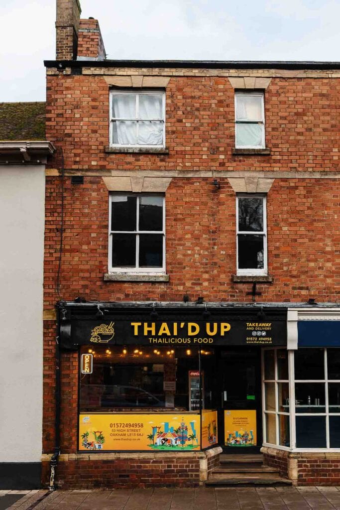 Exterior view of Thai'd Up restaurant in Rutland, showcasing its brick facade and colourful signage for authentic Thai cuisine.