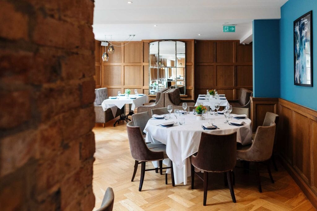 Stylish restaurant interior featuring round tables set for dining, comfortable chairs, and contemporary decor, ideal for special occasions or intimate meals in Rutland.