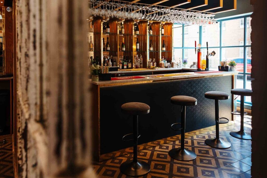 Elegant bar scene showcasing stylish seating and a well-stocked drinks display, captured by Rutland food photographer to highlight hospitality and bar design.