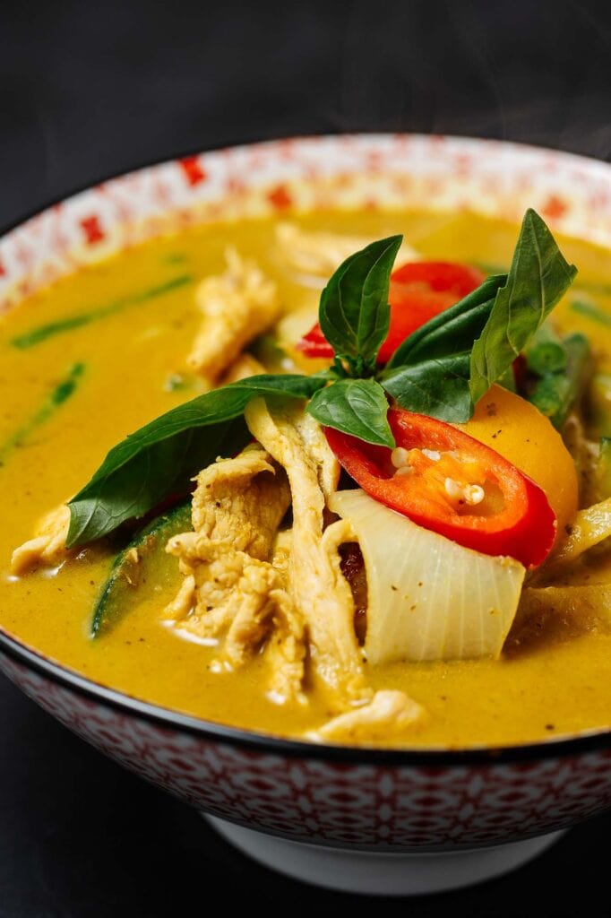 Thai chicken curry with vegetables, herbs, and spices, showcasing a colourful and appetising dish perfect for food photography.