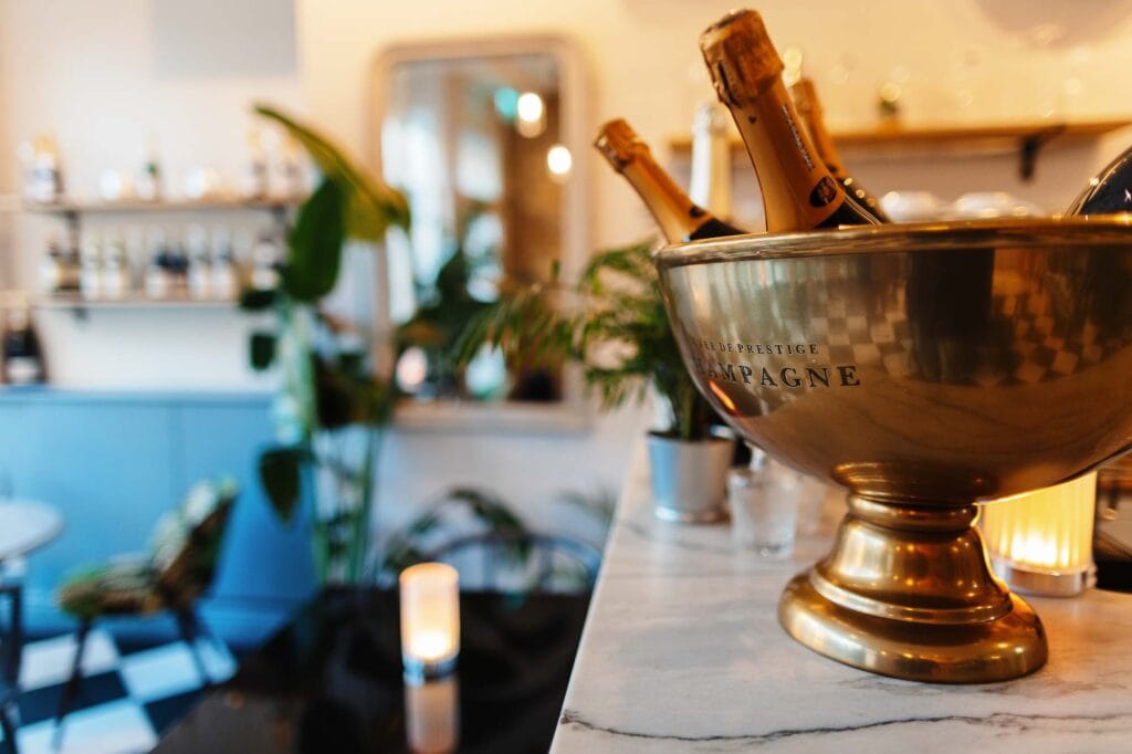 Champagne bottles in a silver bowl at a Rutland food photography shoot, highlighting luxury and celebration themes for food and drink photography.