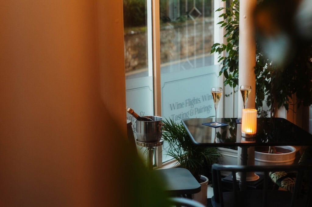 Elegant dining setup with wine glasses and candles in a cosy restaurant setting, captured by a professional food photographer in Rutland.