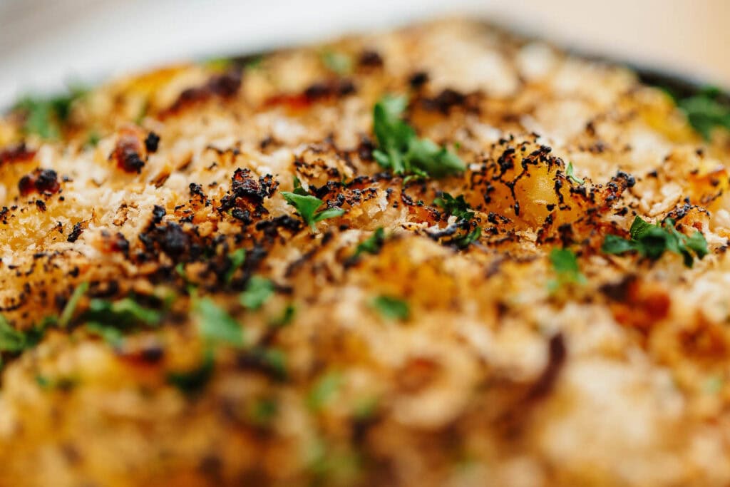 Close-up of roasted cauliflower topped with herbs and crispy breadcrumbs, showcasing a delicious and healthy vegetarian dish.